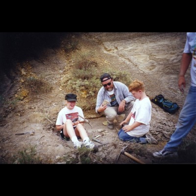 Ray and his son Patrick check out his daughter Corinna's mosasaur find in the fossil filled chalk beds of western Kansas in 1999.