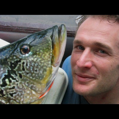 Ray’s portrait of Gary and a peacock bass on one of their Amazon trips.
