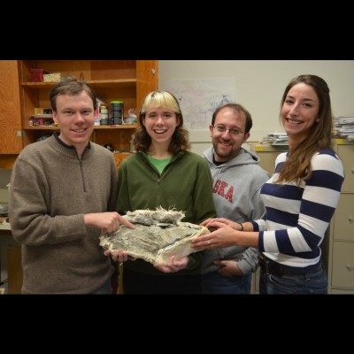 Amy as an undergraduate student at the University of Oregon. They&rsquo;re holding the fossil of a giant spike-toothed salmon.