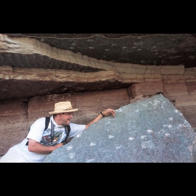 Kirk enjoying ‘fresh’ dinosaur tracks in the canyonlands of Utah. You can see footprints above him too.