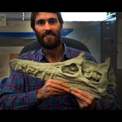 Pat Druckenmiller holding a cast of a Nakonanectes, a short necked elasmosaur (a type of plesiosaur) from the Bearpaw formation of Montana.