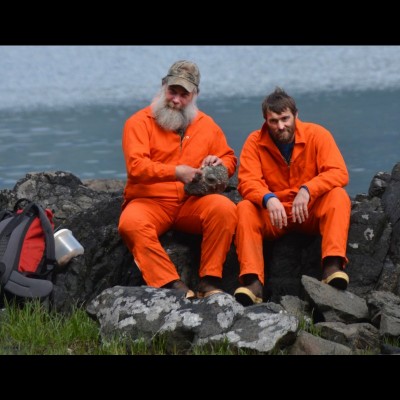 Forest service geologist Jim Baichtal and Pat Druckenmiller fossil hunting on Gravina Island in 2013. Jim’s showing off a nautiloid fossil he found. Those are orange flight suits they’re wearing not prison garb.