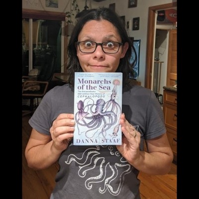 Danna with a copy of Monarchs of the Sea, the paperback version of Squid Empire: The Rise and Fall of the Cephalopods.