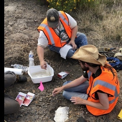 JP (left top) and fellow paleontologist Nathan Van Vranken (right bottom) jacketing an Ornithomimid metatarsal. (Photo by Sarah Hodnett/M-NCPPC).