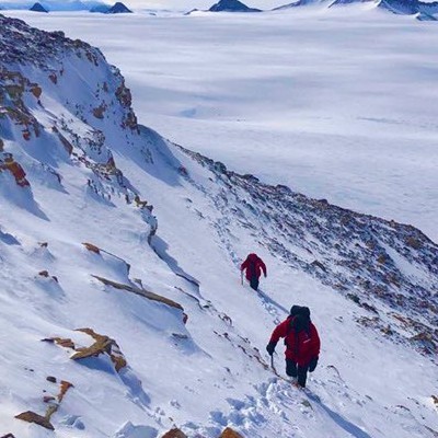 Neil climbing to a fossil site atop Mt Richie, Antarctica 2019.