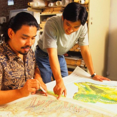 Sam and Roy Kam of the Hawaiʻi Natural Heritage Program, looking over topographical maps and the locations of the rarest species and ecosystems in the Hawaiian archipelago at The Nature Conservancy in 1997.