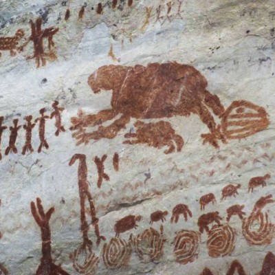 A Recently discovered ancient South American rock art possibly depicting a giant ground sloth with its infant by its side, both bearing large clawed feet.