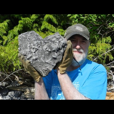 Ray poses with a heart of stone - or 370 million-year-old coral to be more precise!