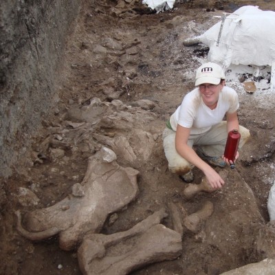 Emily and Eremotherium limb bones at the Tanque Loma asphaltic bone bed locality in Ecuador.