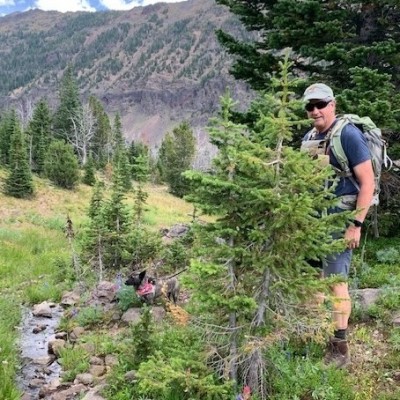 Hiking with his dog, Hya, a jindo mix.