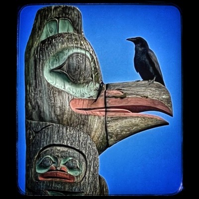Raven meets raven. Dempsey Bob's 'Raven Stealing the Sun ' totem, standing next to the Ketchikan Museum. Photo by Ray Troll