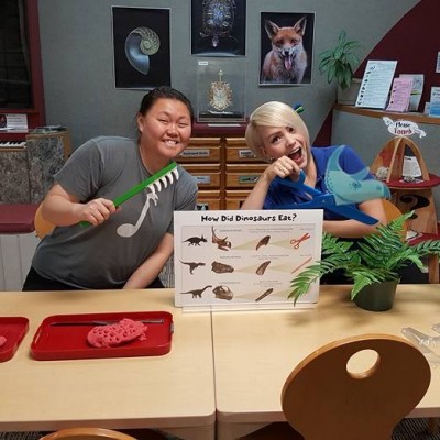 Learning about dinosaurs is fun! Ashley and a volunteer demonstrating the differences in teeth and diet for young visitors at the Cleveland Museum of Natural History.