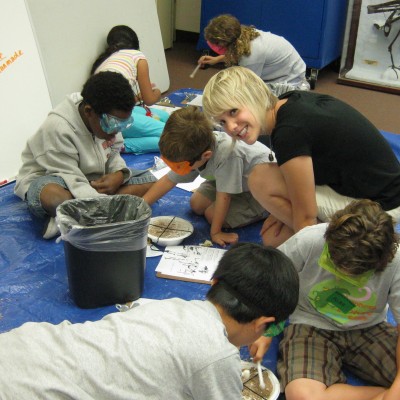 Young paleontologists digging for fossils in mini mock digs at the La Brea Tar Pits summer camp.