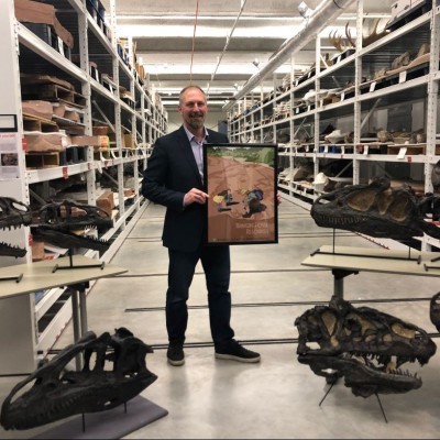 Scott Foss, BLM Senior Paleontologist, holding the new BLM Paleontology Poster. Image source: BLM