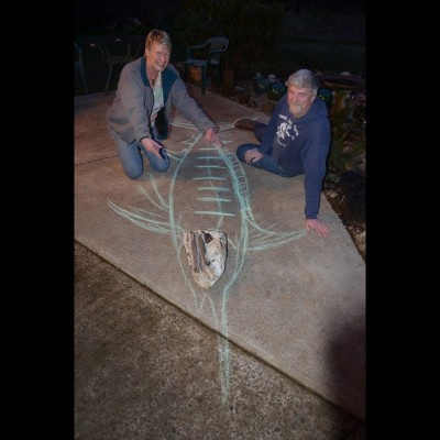 Kent and Lucy Gibson pose with Ray's chalk drawing of the fossil marlin on the evening of the day they met in 2012.
