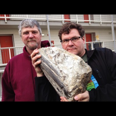 Kirk Johnson embracing Kent's fossil marlin skull that eventually went to the Smithsonian.