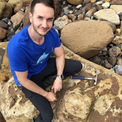 Examining a stegosaur footprint on the beach at Saltwick Bay, Yorkshire. 2020.
