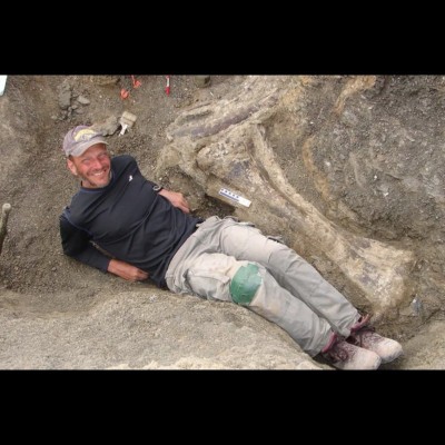 The dig site for Dreadnoughtus schrani in Argentina. Kenneth is sitting next to the tibia (lower leg bone). Photo from Drexel University.