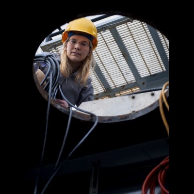 Kelly installing echosounder transducers aboard a research vessel.