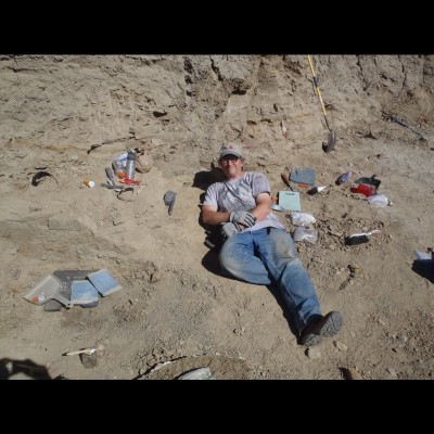 Tom Holtz relaxing in the field, happily chipping away out in the Hell Creek formation. The site is known as "Ninja Turtle" in Carter County, Montana.