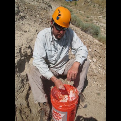 Ed digging deep into a bucket full of plaster at the Spike Tooth Salmon dig site near Gateway, Oregon.