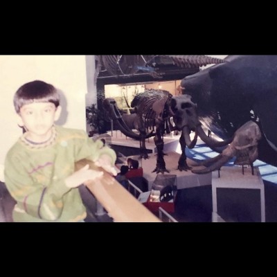 Advait Jukar, age 6, at the Natural History Museum, London with fossil elephants, including the skull of Stegodon ganesa that he would later study