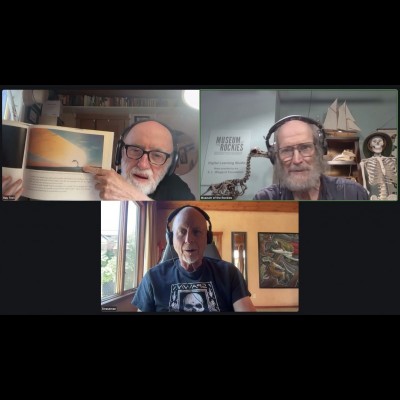 Ray holds up Doug's Asteroid Impact book as Dave looks on. 