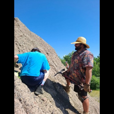 Dr. Arjan Mann digging at the Braceville spoil pile (AKA Pit 11) with a pick axe