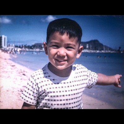 A very young Stuart Sumida on the beach at Waikiki in Hawaii