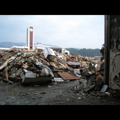 Rikuzen Takata City Museum was totally submeged in the 2011 Tsunami. This is a view from the museum entrance looking at the city gymnasium across the park. The debris from the museum was piled up in front of the museum in April 2011.