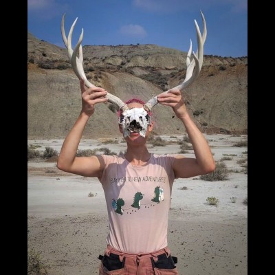 Melanie in North Dakota with a mule deer skull, because she cannot behave normally around dead things!