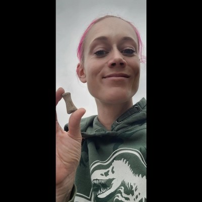 Melanie in the Mud Buttes area in North Dakota with a potential crocodylian phalange she just found.